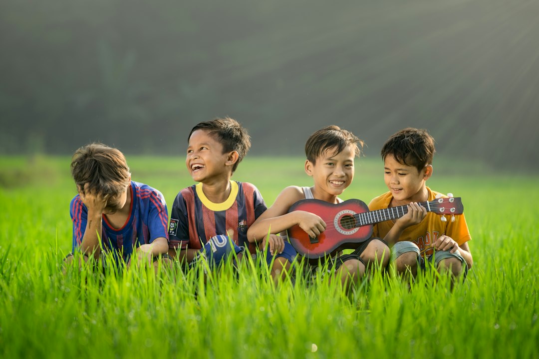 Jakarta shoot by Bike Brands four boys laughing and sitting on grass during daytime