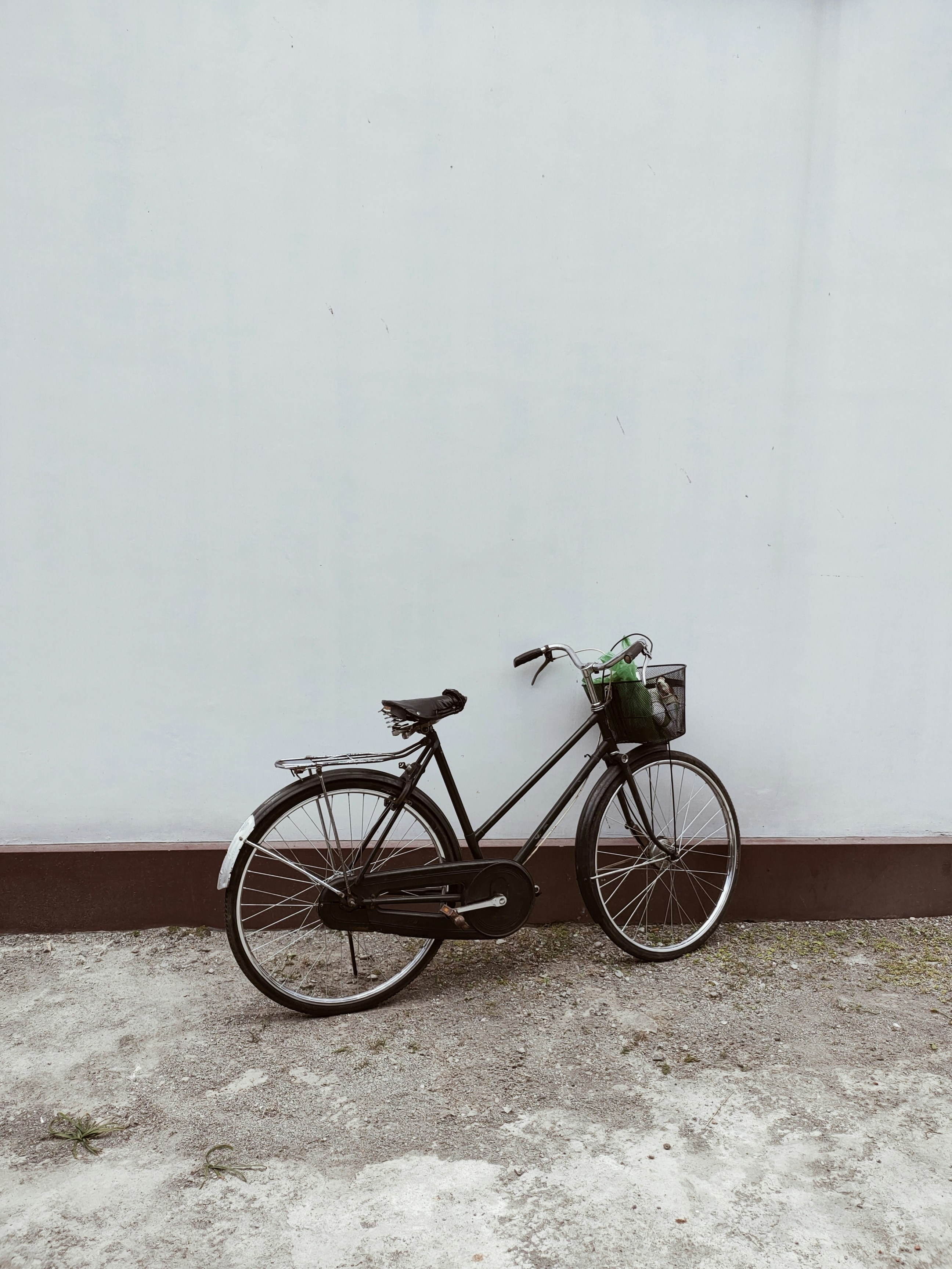 🚲 The Evolution of Bike Brands: A Ride Through History by Bike Brands a bicycle parked against a wall with a basket