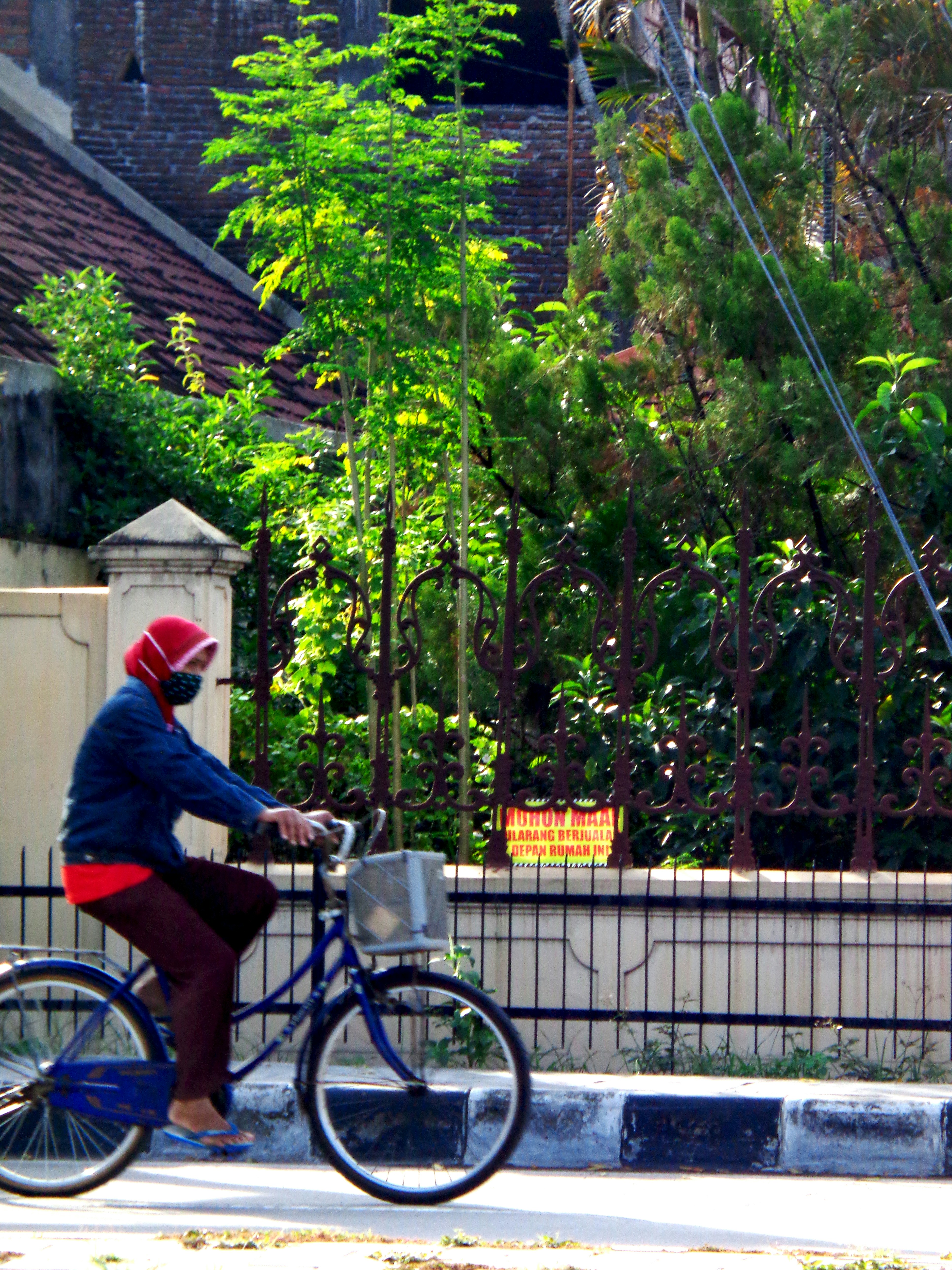 a person riding a bike with a bucket on the back