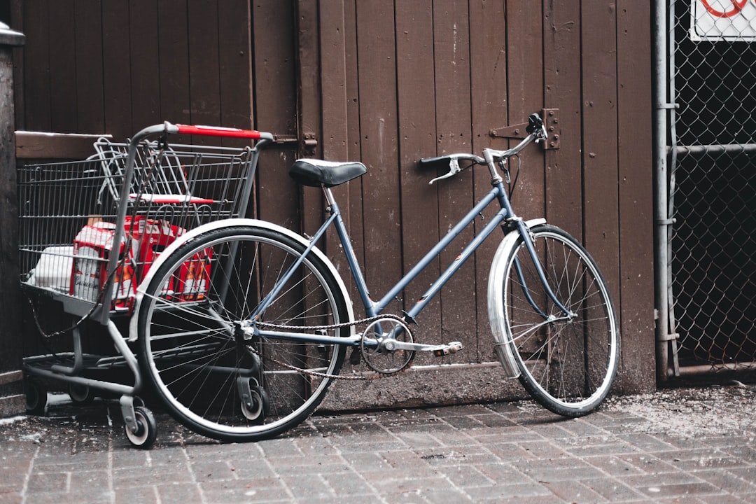 🚴♂️ A Brief History of Two-Wheeled Wonders: Understanding Bicycle Evolution by Bike Brands a bicycle parked next to a building with a basket on the front