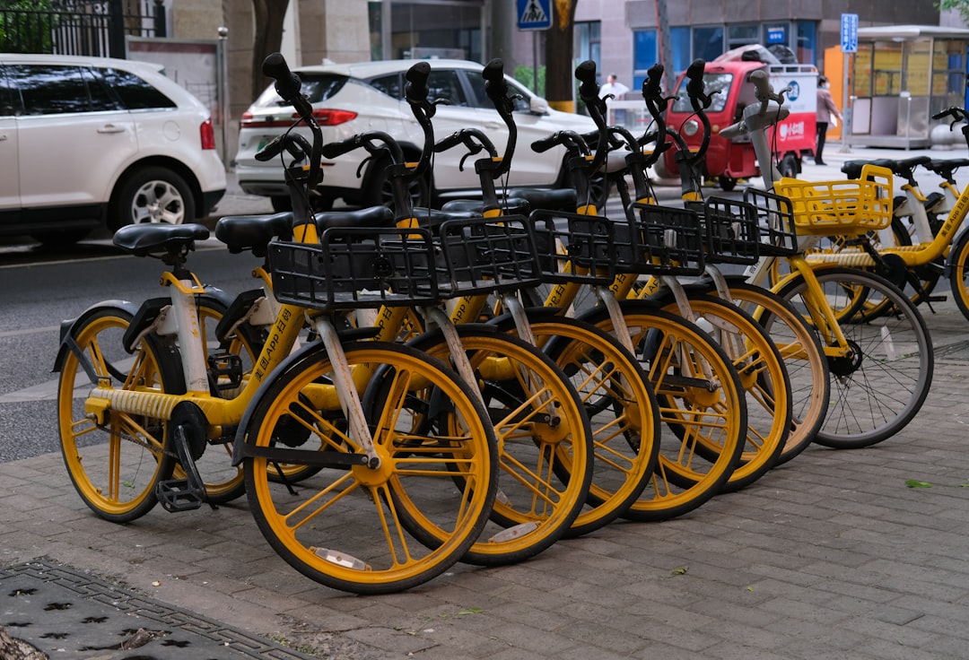 a row of yellow bicycles parked next to each other